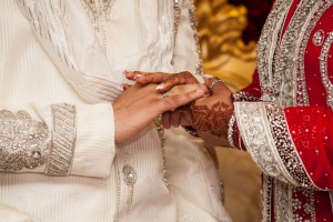 Bengali bride and groom holding hands on their wedding day