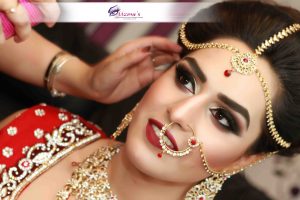 Photo of an Asian Bride wearing traditional red dress and red themed Asian Bridal Makeup